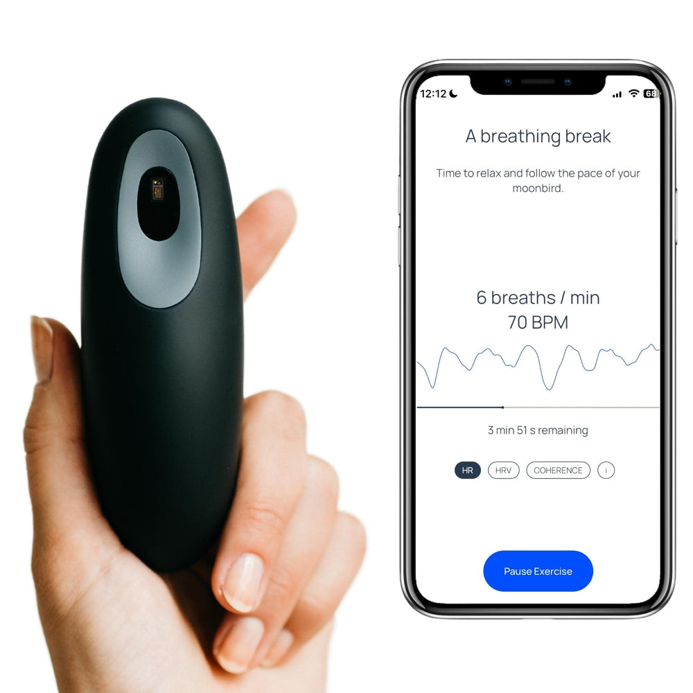 Moonbird breathing tool in hand for quick calm before bed.