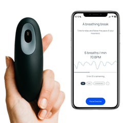 Moonbird breathing tool in hand for quick calm before bed.