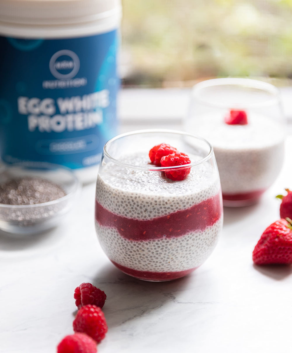 MRM Egg White Protein Chocolate shake beside glass in kitchen