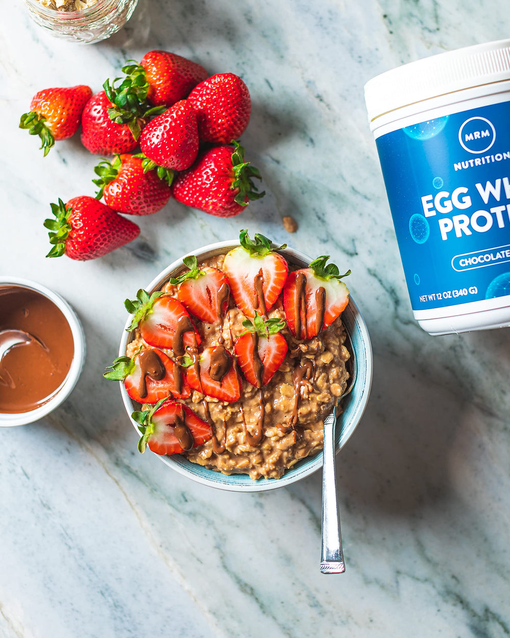 MRM Egg White Protein Chocolate tin packaging on counter