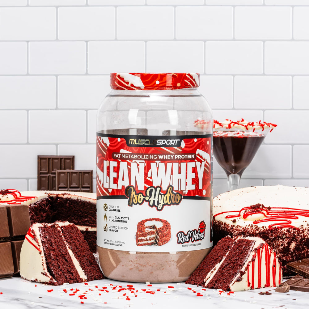 Scoop pouring Lean Whey Revolution into a shaker for mixing.