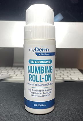 Myderm roll-on on skin for instant numbing.