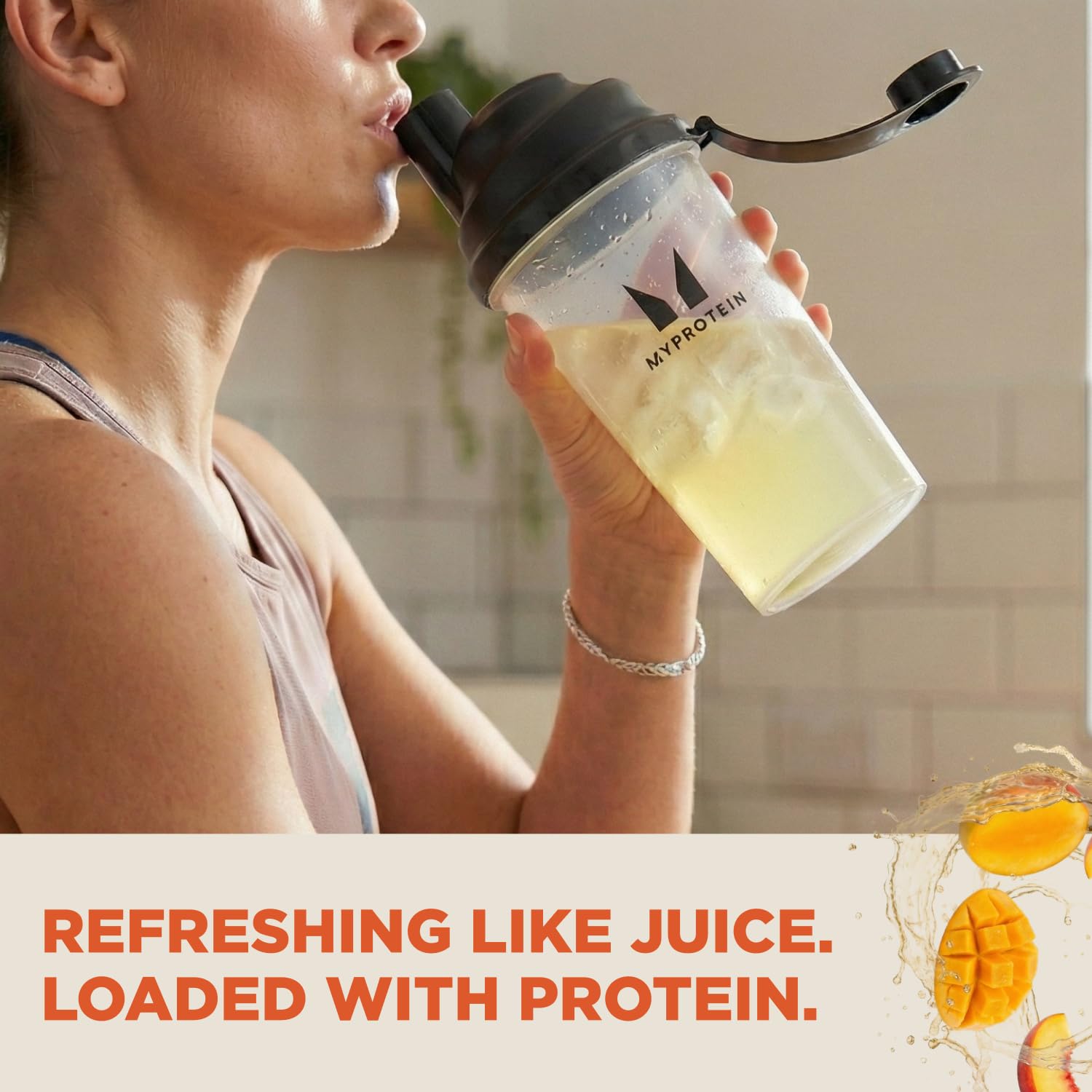 Myprotein Clear Whey Isolate Peach Mango scoop closeup, high-quality protein for muscle maintenance.