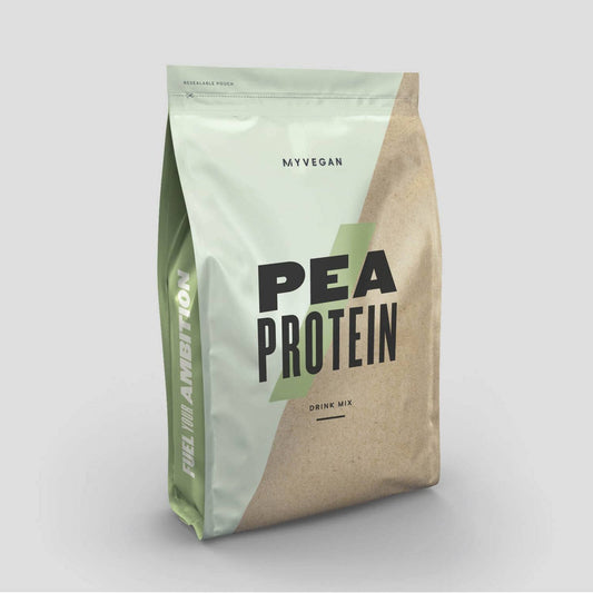 Pouring mocha MyVEGAN pea protein shake into a glass for mixing.