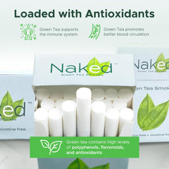 Naked Green Tea Smokes burning evenly beside carton demonstrates consistent burn.