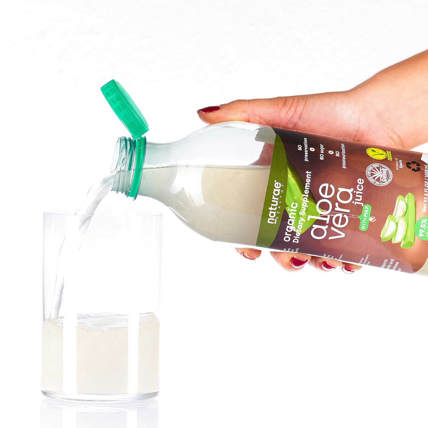 Naturae Aloe Vera Juice pours into a glass for a smooth, refreshing sip.