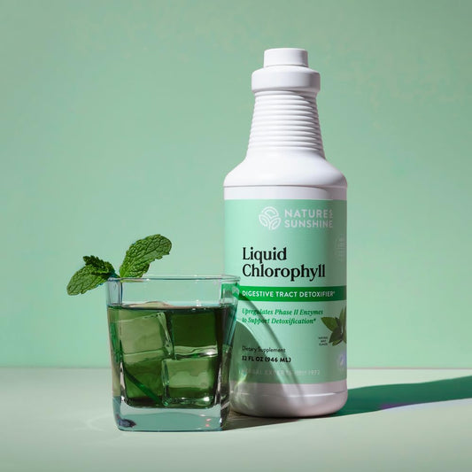 Nature's Sunshine chlorophyll drops pour into glass for daily detox.