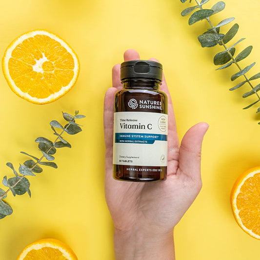 Close-up of Nature's Sunshine Vitamin C Time Release tablets showing time-release coating for steady intake.