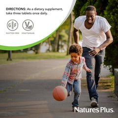 NaturesPlus Ultra Source of Life No-Iron capsules pouring from bottle cap for daily ritual.