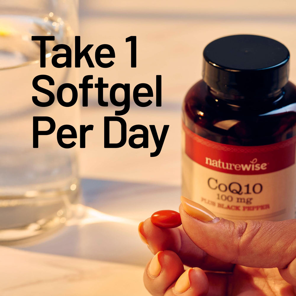 NatureWise CoQ10 softgels beside a glass of water for daily energy support.