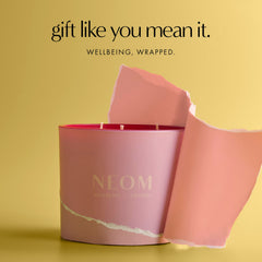 NEOM It's All Rosy Candle rose scent close-up highlights fragrance.