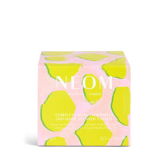 NEOM Complete Bliss candle lit outdoors on a balcony for calm ambience