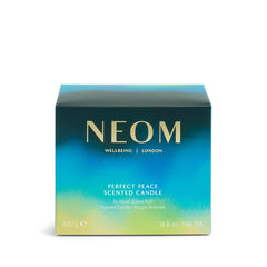 NEOM Perfect Peace on a table beside a book for a calm evening