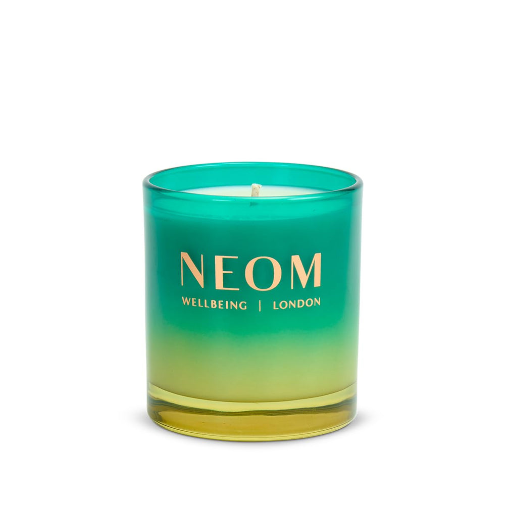 Illuminated NEOM Perfect Peace candle fills room with uplifting spa-like ambience.