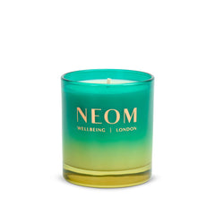 Illuminated NEOM Perfect Peace candle fills room with uplifting spa-like ambience.