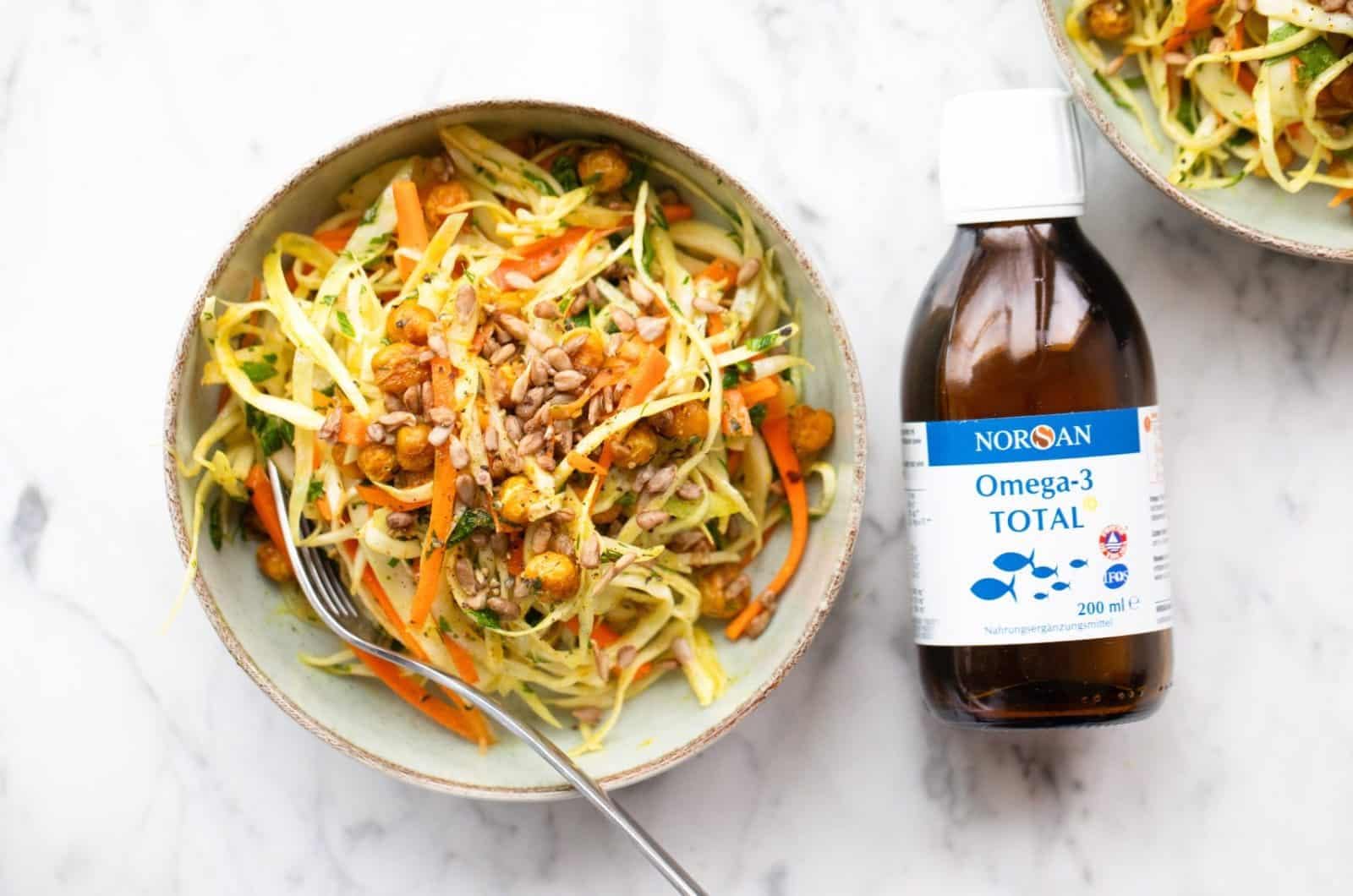 NORSAN Omega-3 Total liquid bottle on the counter for daily dosing.