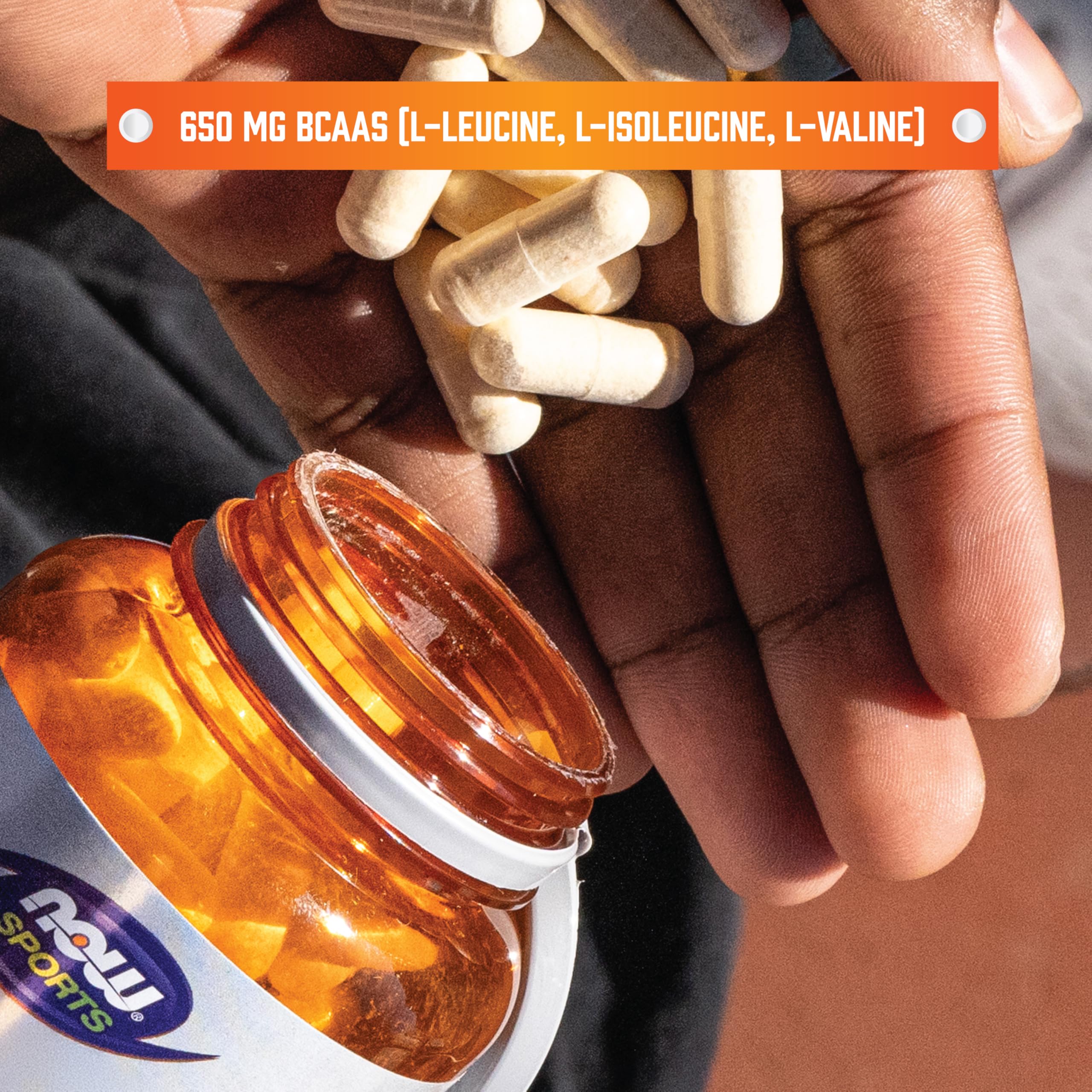 NOW Foods BCAAs bottle pouring out capsules for post-workout support.