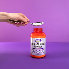 Measuring scoop beside a shaker for consistent daily dosing.