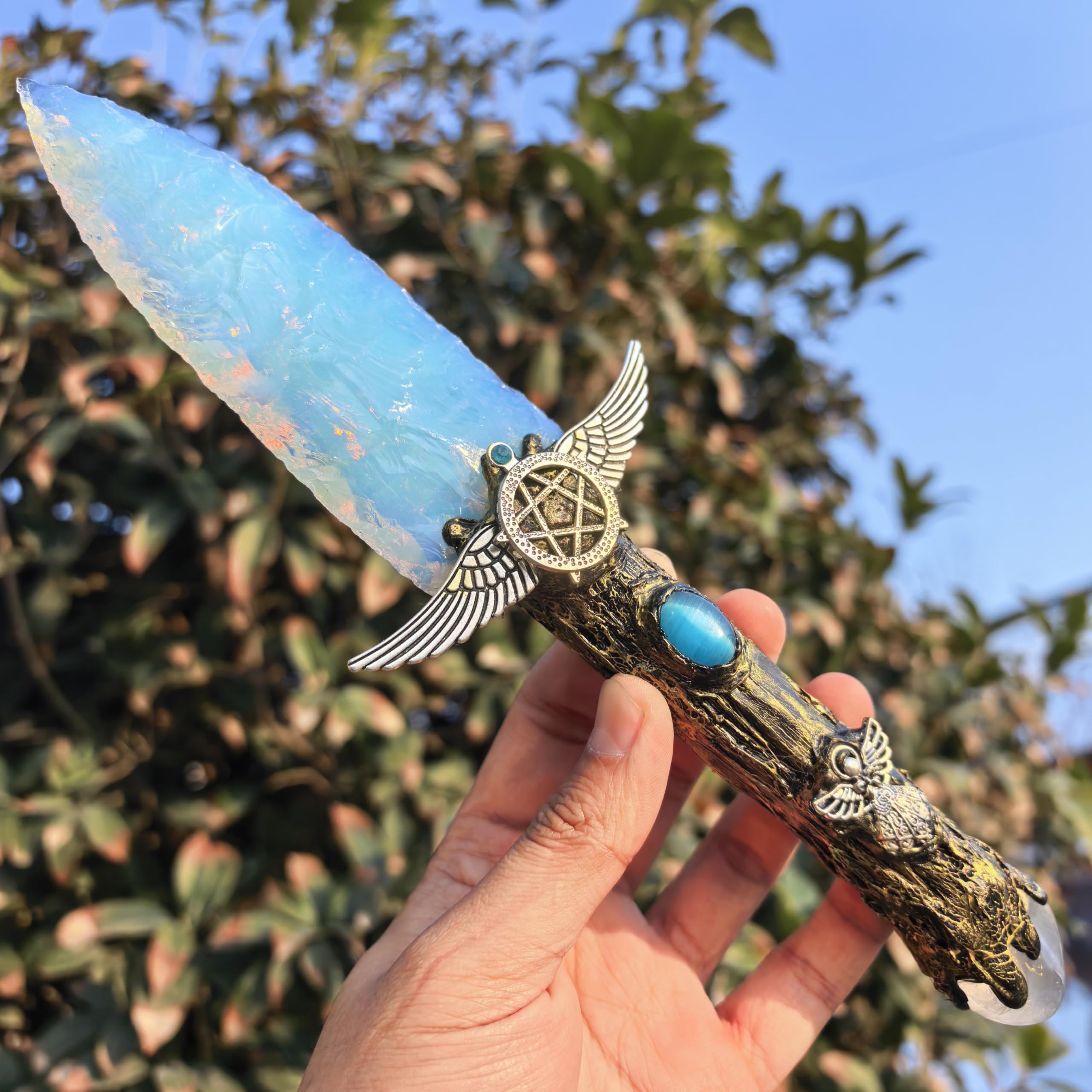 NsmjodStone opal obsidian crystal with resin handle for tactile display and spiritual ambiance.