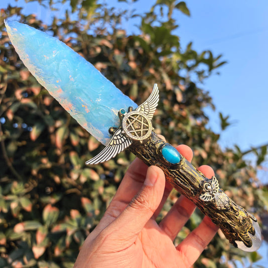 NsmjodStone opal obsidian crystal with resin handle for tactile display and spiritual ambiance.