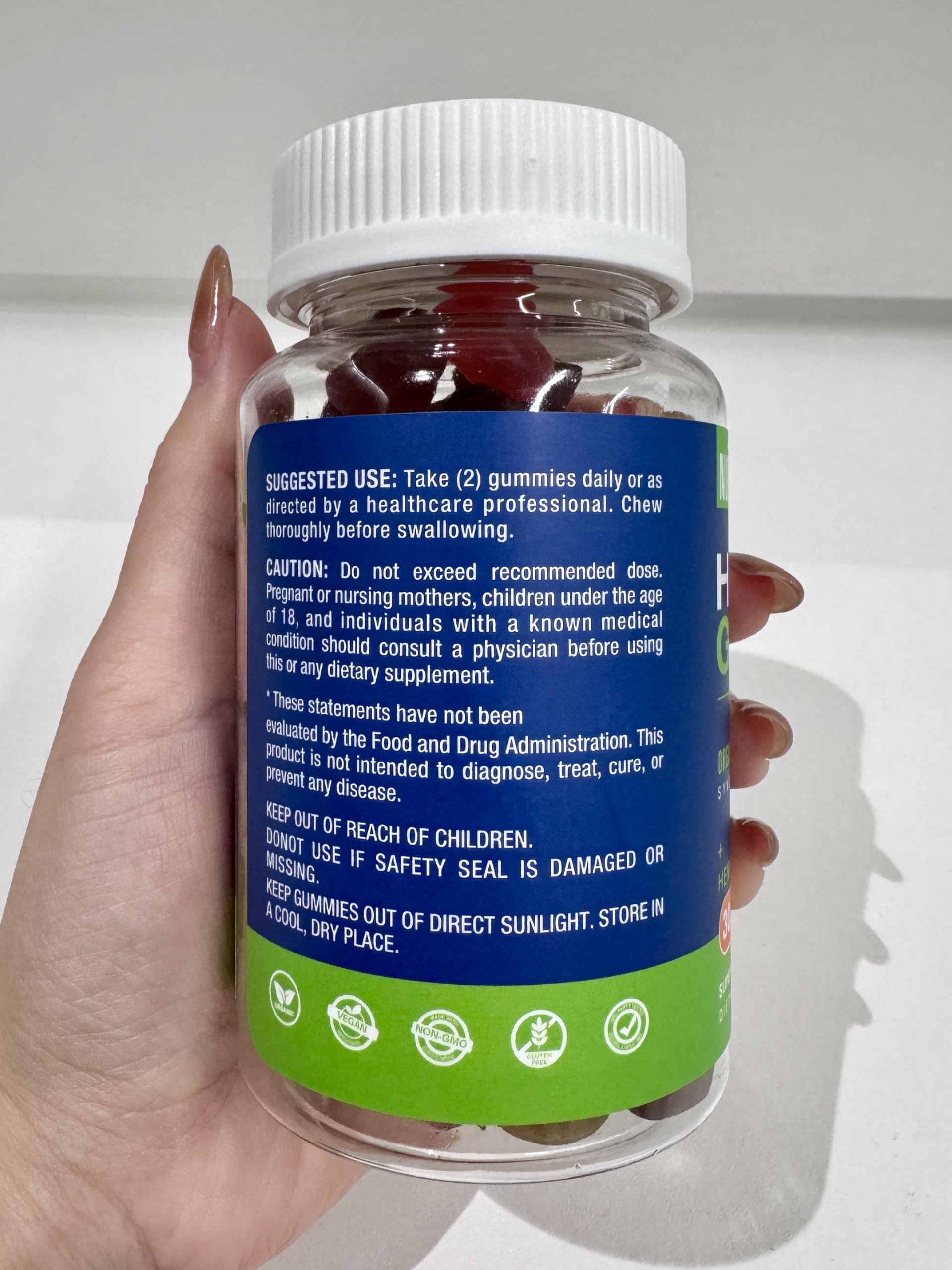 Serving suggestion beside a glass of water with Nubetong gummies