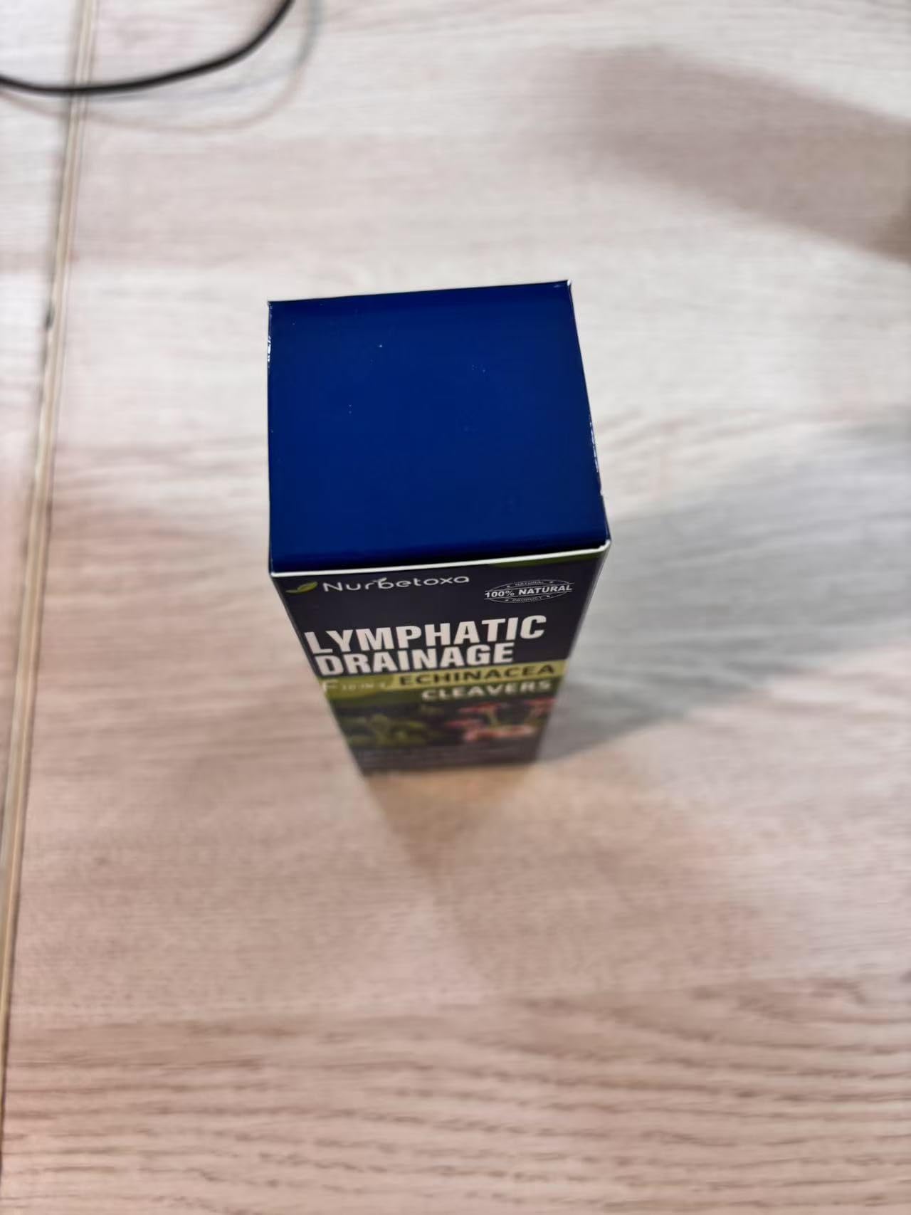 Close-up of Nurbetoxa herbal blend drops bottle showing plant-based ingredients