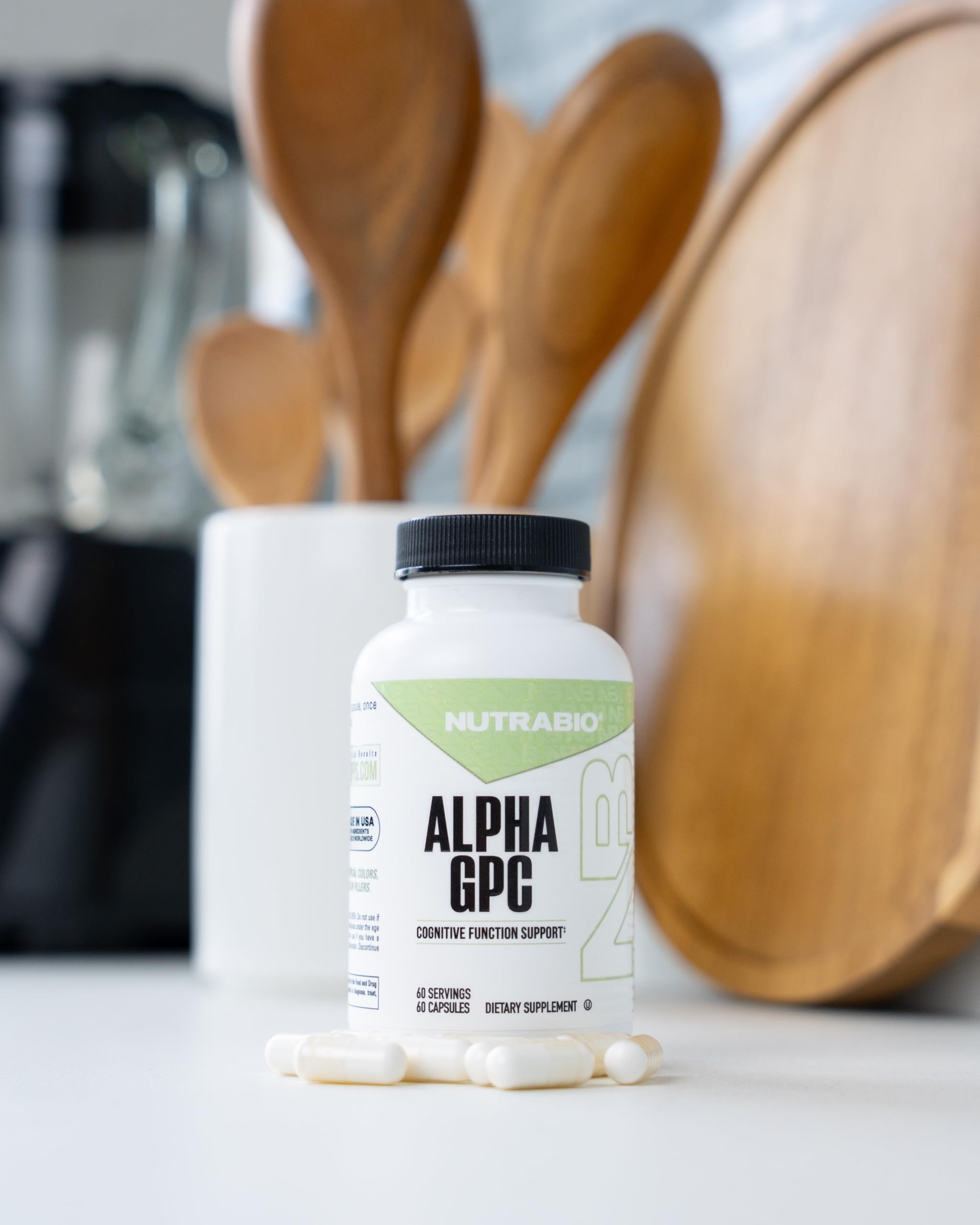 NutraBio Alpha GPC bottle with glass suggesting a mindful cognitive routine