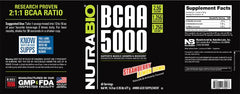 NutraBio BCAA 5000 Strawberry Lemon Bomb being poured into a glass for intra-workout use.
