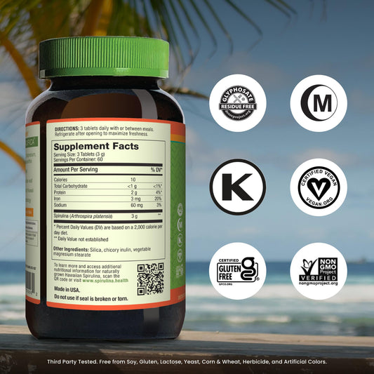 Nutrex Hawaii spirulina tablets on kitchen counter for easy daily use.