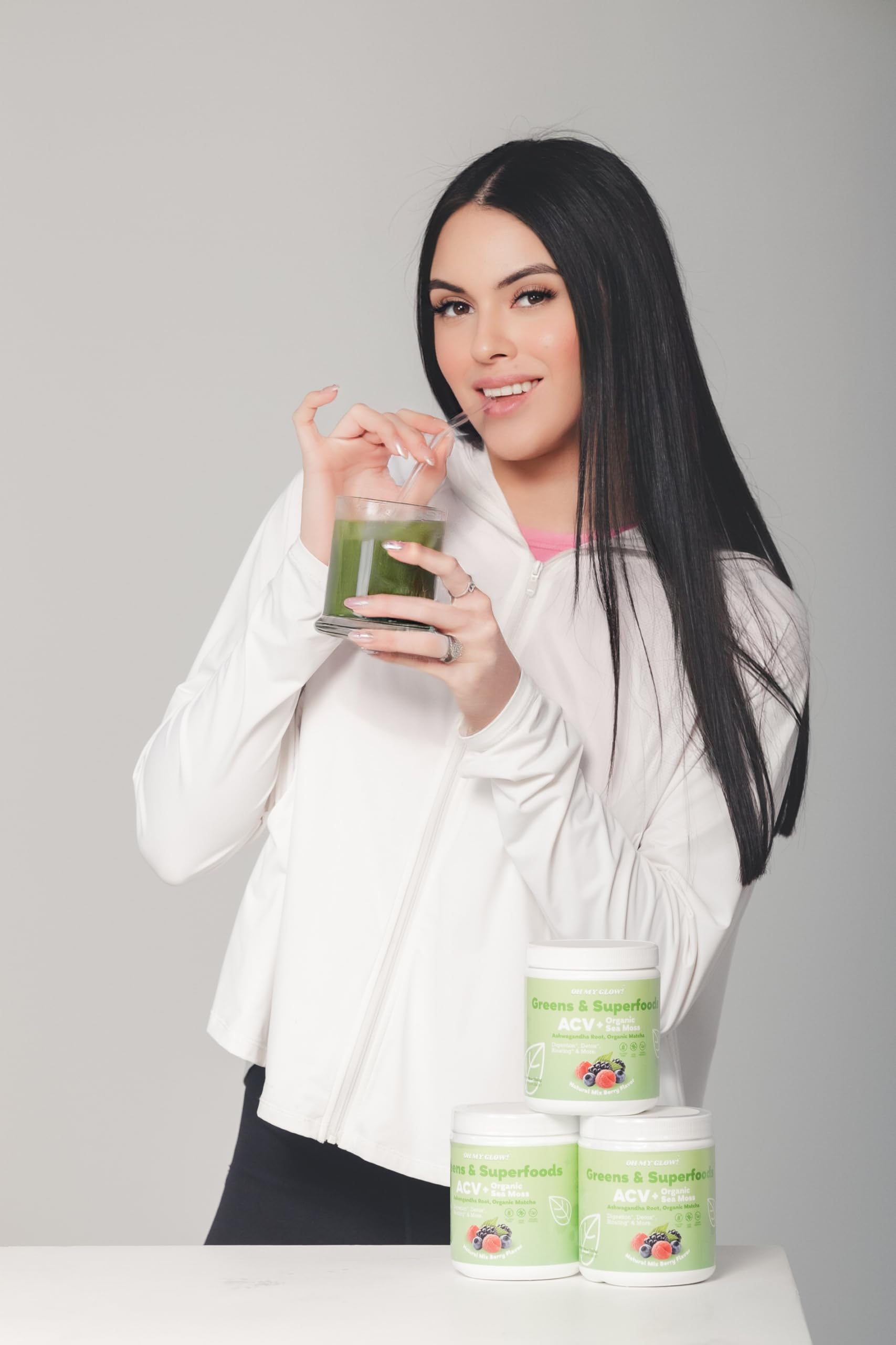 Oh My Glow! Super Greens ACV & sea moss on counter for wellness.