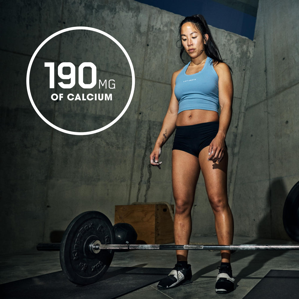 Optimum Nutrition Opti-Women bottle in gym setting for active lifestyle.