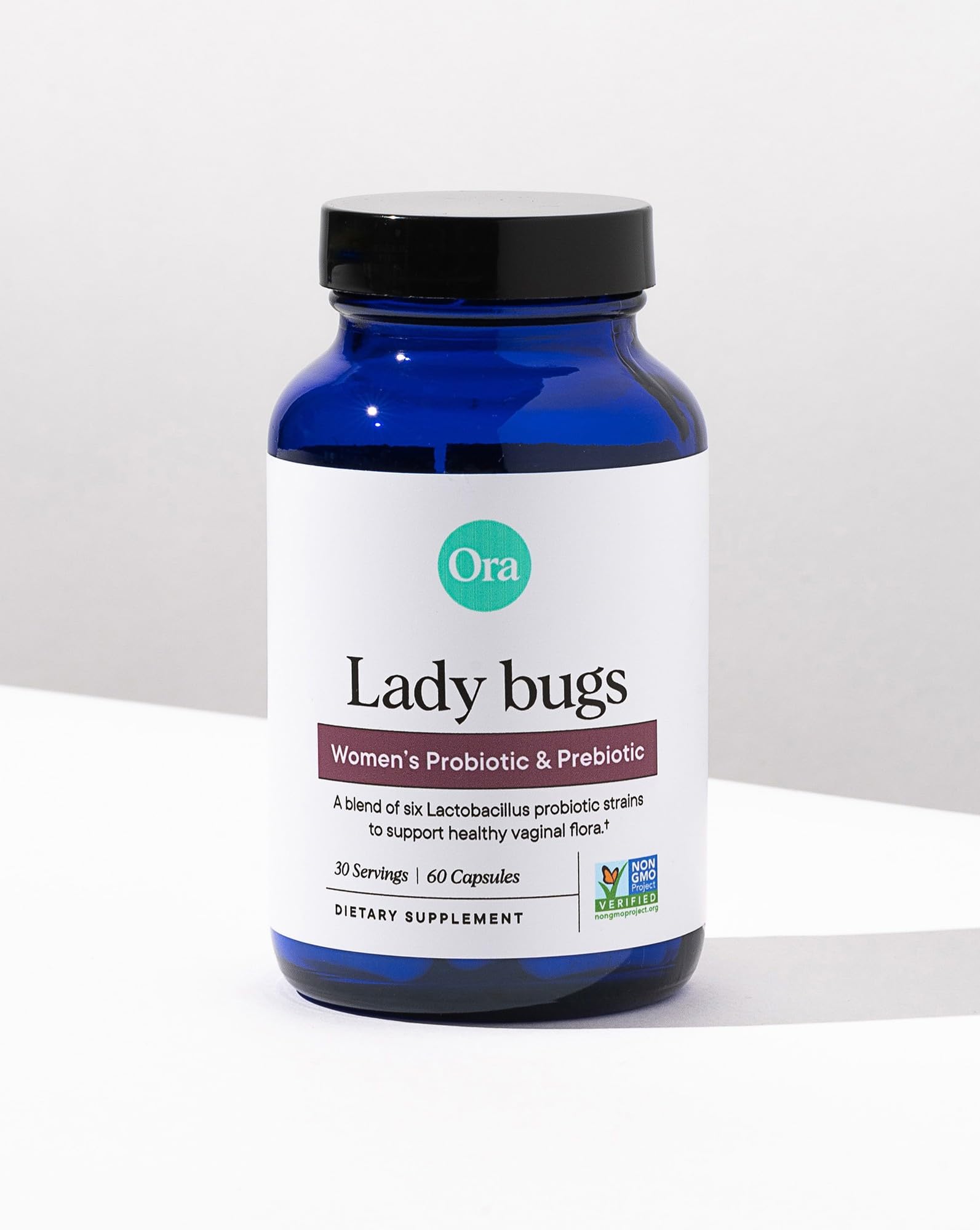 Ora Organic daily-use bottle sits beside water, inviting an easy wellness routine.