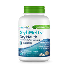 Oracoat XyliMelts discs on teeth providing long-lasting moisture.