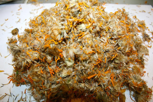 Arnica dried closeup flakes with a golden-brown texture suitable for blends.