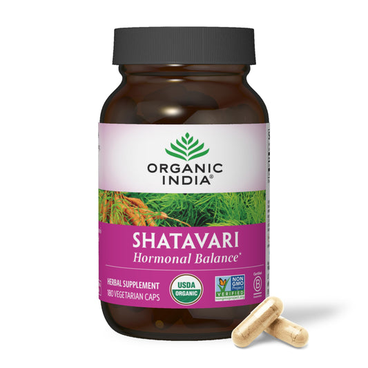 Organic India Shatavari capsules bottle on counter, supporting hormonal balance.