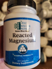 Ortho Molecular Reacted Magnesium bottle pouring, supports daily magnesium intake for balanced wellness.