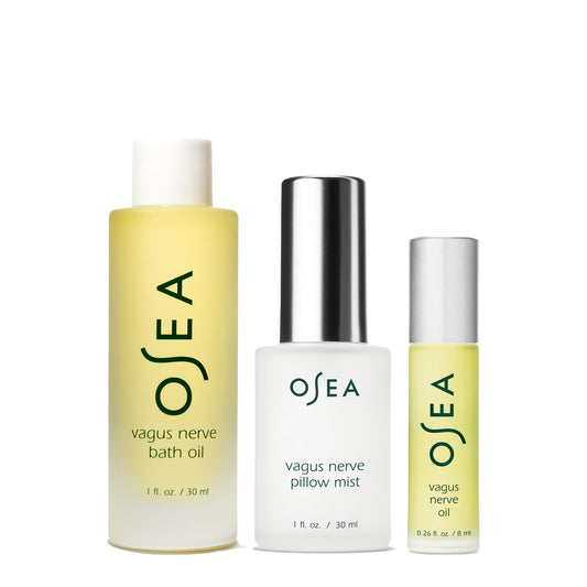 OSEA Vagus Nerve Bath Oil being poured into warm water for a soothing soak