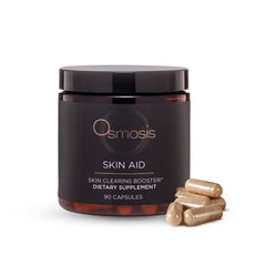 OSMOSIS Skin Aid bottle on wood surface suggesting microbiome support and skin vitality