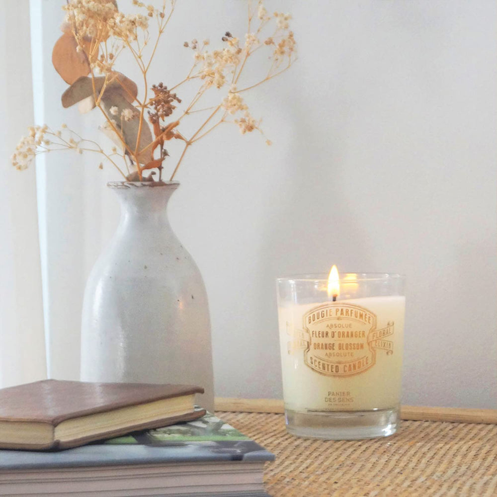 Panier des Sens orange blossom candle lit glow fills a space with warmth.