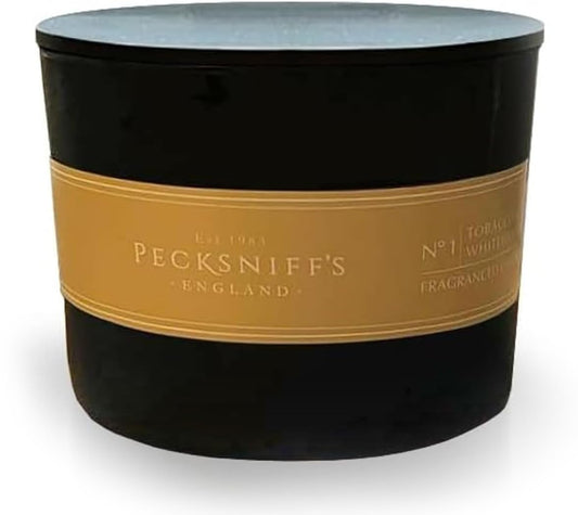 Pecksniff's Black Tobacco & White Wood candle with three wicks for an even, radiant burn.