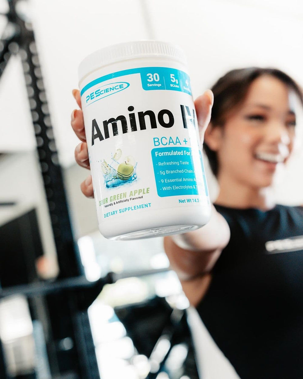 PEScience Amino IV mixing a shake in a glass after training
