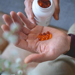 Pouring Pharmanex Marine Omega softgels for easy daily use