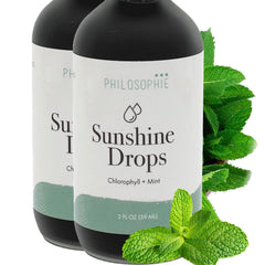 Philosophie Liquid Chlorophyll Sunshine Drops bottle on a kitchen counter, promoting hydration and wellness.