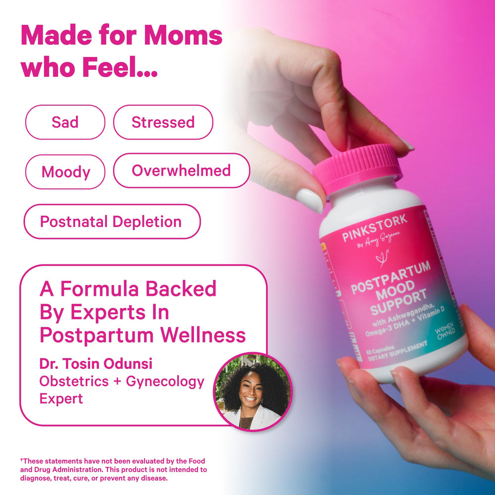 Pink Stork Postpartum Mood Support packaging on a bedside table.