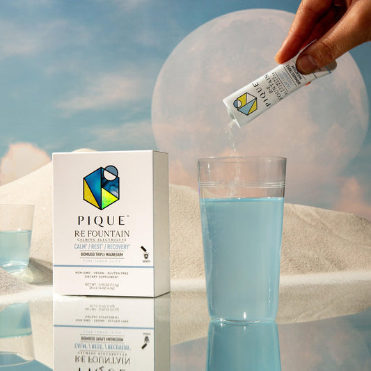 Single-serve PIQUE RE Fountain stick stirred in water for easy hydration.