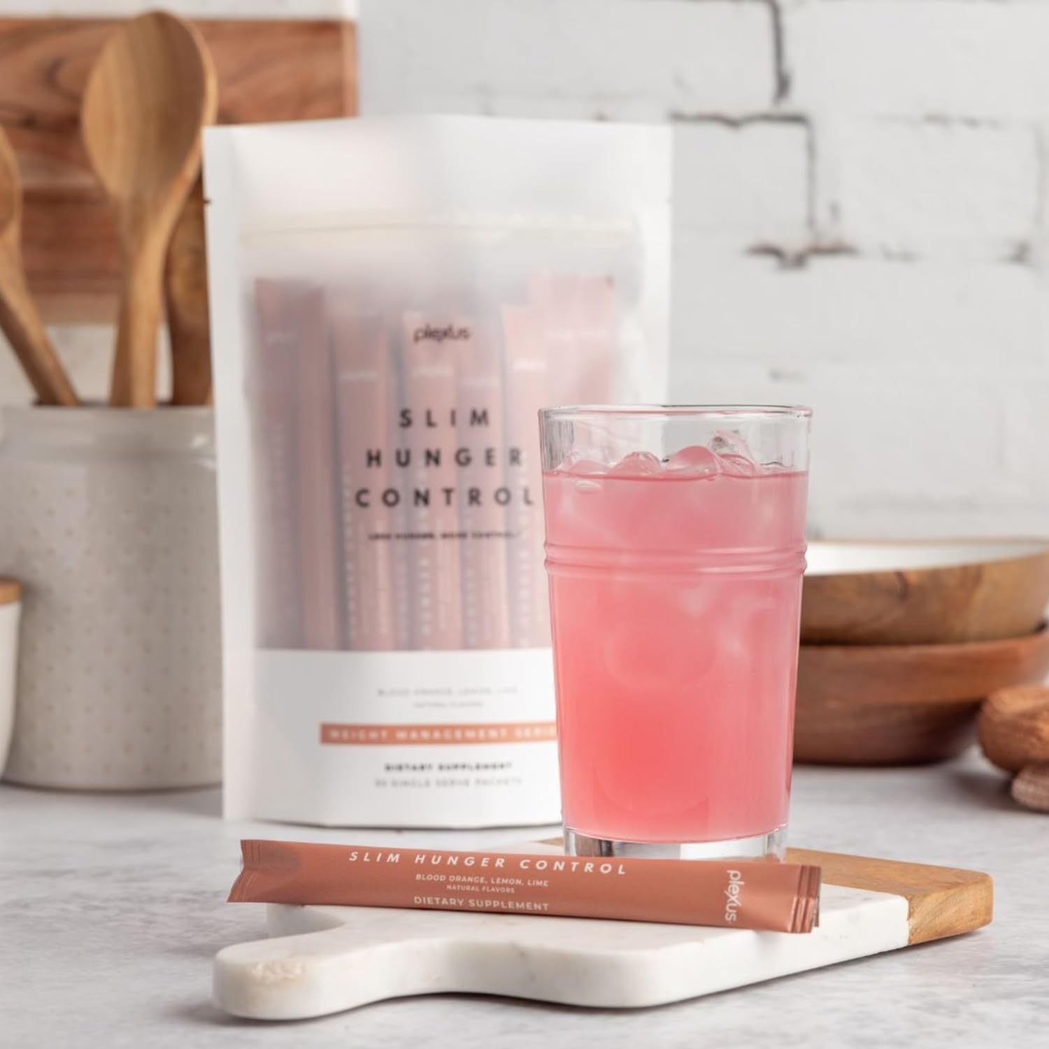 Plexus Slim Hunger Control on-the-go packet dissolving in water for a quick morning routine.