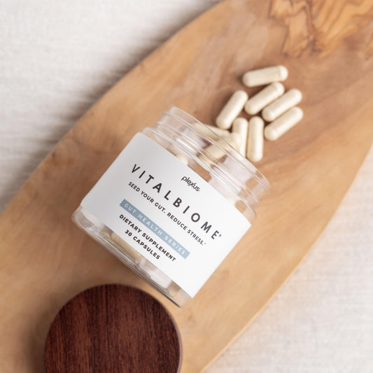 Plexus VitalBiome capsule being poured to support gut comfort