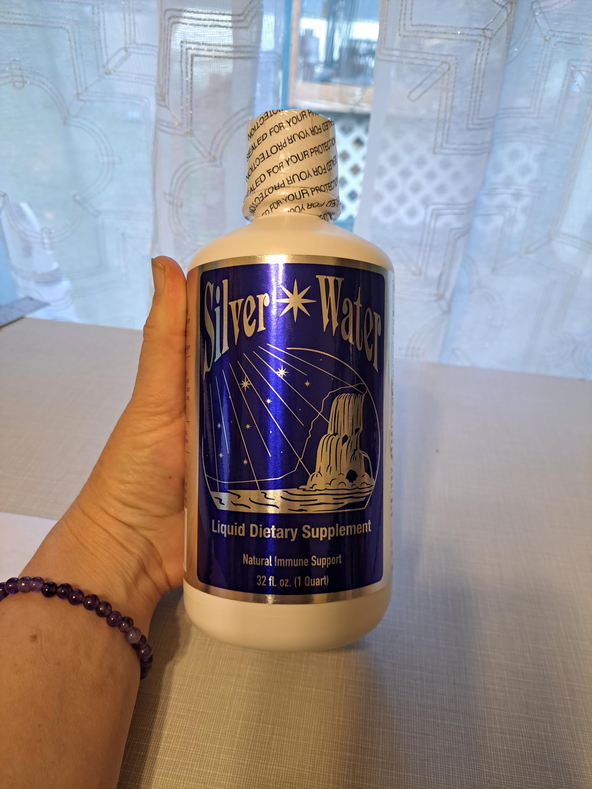 SILVER WATER COMPANY premium bottle with silver liquid splash, emphasizing professional-grade quality for everyday routines