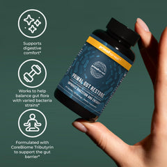 Primal Harvest Restore capsules in hand for a daily wellness routine