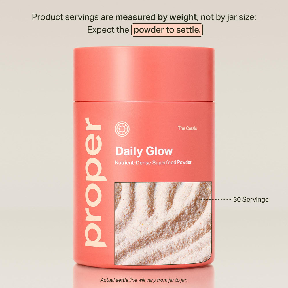 Proper Corals Daily Glow scoop dissolving in water for a refreshing glow